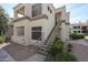 Exterior view of building, showing outdoor stairs, neutral color scheme, and well-maintained landscaping at 11375 E Sahuaro Dr # 1053, Scottsdale, AZ 85259