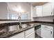 Featuring a stainless steel sink and granite countertops, this kitchen has lots of natural light at 11375 E Sahuaro Dr # 1053, Scottsdale, AZ 85259