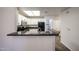 This kitchen boasts granite countertops, white cabinets, and a convenient breakfast bar for casual dining at 11375 E Sahuaro Dr # 1053, Scottsdale, AZ 85259