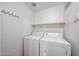 Practical laundry room offering essential appliances and storage space for household tasks at 11375 E Sahuaro Dr # 1053, Scottsdale, AZ 85259