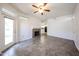 Open-concept living room showcases tile flooring, cozy fireplace, ceiling fan, and easy access to the kitchen at 11375 E Sahuaro Dr # 1053, Scottsdale, AZ 85259