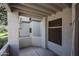Covered patio with desert landscaping views, tan stucco walls, privacy wall and access door for unit at 11375 E Sahuaro Dr # 1053, Scottsdale, AZ 85259