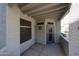 Covered patio with stucco privacy wall, screen windows, access door, and concrete patio at 11375 E Sahuaro Dr # 1053, Scottsdale, AZ 85259