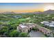 Aerial view of estate on golf course with tiled roof, and mature desert landscaping at 11548 E Salero Dr, Scottsdale, AZ 85262