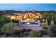 Aerial view of estate featuring a pool, covered patio and lush landscaping at 11548 E Salero Dr, Scottsdale, AZ 85262