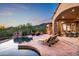 Spacious backyard with pool, spa, lounge chairs and outdoor seating area at 11548 E Salero Dr, Scottsdale, AZ 85262