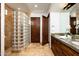 Well-appointed bathroom showcasing a glass block shower, granite countertops, and custom cabinets at 11548 E Salero Dr, Scottsdale, AZ 85262