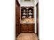 Butler's pantry boasting custom cabinetry, tile backsplash, and a granite countertop at 11548 E Salero Dr, Scottsdale, AZ 85262