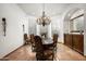 Formal dining room featuring a chandelier and a large window providing ample natural light at 11548 E Salero Dr, Scottsdale, AZ 85262