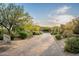 A well-manicured driveway leads up to a beautiful home with lush desert landscaping at 11548 E Salero Dr, Scottsdale, AZ 85262