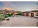 Circular driveway leading to a luxury home with stone accents and mature landscaping at 11548 E Salero Dr, Scottsdale, AZ 85262