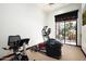 Bright exercise room featuring an elliptical, exercise bike and sliding glass door access to outside at 11548 E Salero Dr, Scottsdale, AZ 85262