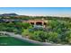 A stunning desert home boasts an inviting outdoor pool and beautiful landscaping at 11548 E Salero Dr, Scottsdale, AZ 85262