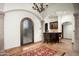 Grand foyer with travertine floors, arched doorways, and custom iron accents, creating a sophisticated entryway at 11548 E Salero Dr, Scottsdale, AZ 85262