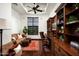 Spacious home office with coffered ceiling, built-in bookshelves, a leather desk chair and warm lighting at 11548 E Salero Dr, Scottsdale, AZ 85262