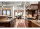 Gourmet kitchen with stone hood over range and views of the breakfast nook and outdoor living spaces at 11548 E Salero Dr, Scottsdale, AZ 85262