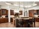 Gourmet kitchen island with barstool seating, granite countertop, and custom cabinetry at 11548 E Salero Dr, Scottsdale, AZ 85262