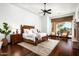 Serene main bedroom features a sitting area, ceiling fan, and large windows showcasing desert views at 11548 E Salero Dr, Scottsdale, AZ 85262
