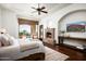 Bright main bedroom with a fireplace, TV, and comfortable sitting area with desert views at 11548 E Salero Dr, Scottsdale, AZ 85262