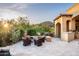 Outdoor kitchen and fire pit area, complemented by beautiful desert landscaping and a covered patio, perfect for gatherings at 11548 E Salero Dr, Scottsdale, AZ 85262