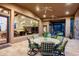 Stylish covered patio with a cozy seating area and dining space, offering views of the living room with a fireplace at 11548 E Salero Dr, Scottsdale, AZ 85262