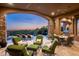 Inviting covered patio with comfortable seating, a built-in grill, and stunning views of the pool and desert scenery at 11548 E Salero Dr, Scottsdale, AZ 85262