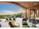 An inviting covered patio featuring comfortable lounge seating, outdoor dining, and scenic desert views at 11548 E Salero Dr, Scottsdale, AZ 85262