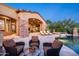 Stunning pool area with a covered patio, comfortable seating, and lush landscaping, perfect for outdoor relaxation at 11548 E Salero Dr, Scottsdale, AZ 85262