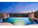 Beautiful pool overlooking desert landscape with stacked stone columns and sunset skies at 11548 E Salero Dr, Scottsdale, AZ 85262