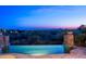 Luxury home featuring a tranquil pool with scenic desert and sunset views and stone accents at 11548 E Salero Dr, Scottsdale, AZ 85262