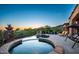 Resort-style pool and spa area with desert landscape, lounge seating, and picturesque twilight views at 11548 E Salero Dr, Scottsdale, AZ 85262
