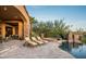 Inviting backyard featuring a pool, hot tub, stone accents, and comfortable lounge chairs at 11548 E Salero Dr, Scottsdale, AZ 85262