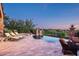 Patio with pool, spa, desert views, brick pavers and seating with lounge chairs at 11548 E Salero Dr, Scottsdale, AZ 85262