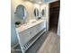 Bright bathroom featuring a double sink vanity with a marble countertop and decorative mirrors at 12044 S 45Th St, Phoenix, AZ 85044