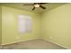 Carpeted bedroom featuring ceiling fan, light fixtures, and light green walls and one window at 12044 S 45Th St, Phoenix, AZ 85044