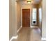 Interior entryway featuring a wood door, window with blinds and wood floors at 12044 S 45Th St, Phoenix, AZ 85044