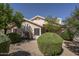 Home exterior features a desert landscape with mature bushes and beige stucco at 12044 S 45Th St, Phoenix, AZ 85044
