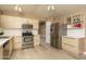 Kitchen features stainless steel appliances, modern light wood cabinets, and vinyl flooring at 12044 S 45Th St, Phoenix, AZ 85044