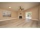 Spacious living room featuring a fireplace, vaulted ceiling, large windows, and vinyl flooring at 12044 S 45Th St, Phoenix, AZ 85044