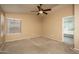 Neutral bedroom includes a ceiling fan, window, and door to the ensuite bath at 12044 S 45Th St, Phoenix, AZ 85044