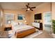 Spacious main bedroom boasts a ceiling fan, modern decor, and an ensuite bath at 12044 S 45Th St, Phoenix, AZ 85044