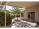 Covered patio area with a tree and a view of the landscaped backyard at 12044 S 45Th St, Phoenix, AZ 85044