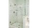 Marble tiled shower with pebble floor, and frameless glass at 12044 S 45Th St, Phoenix, AZ 85044