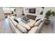 Spacious living room featuring a large sectional sofa, modern art, and access to an outdoor space at 12633 W Luxton Ln, Avondale, AZ 85323