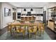 Modern kitchen and dining area with white cabinets, an island with seating, and pendant lighting at 12647 W Parkway Ln, Avondale, AZ 85323