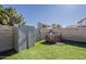 Fenced backyard features artificial turf, an outdoor shed and brick fire pit for outdoor gatherings at 15360 N 87Th Ave, Peoria, AZ 85381