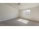 Neutral bedroom featuring a ceiling fan, carpet, and a sunny window at 15360 N 87Th Ave, Peoria, AZ 85381