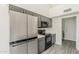 Modern kitchen with stainless steel appliances, gray cabinets, and sleek countertops at 15360 N 87Th Ave, Peoria, AZ 85381