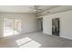 Large main bedroom featuring a ceiling fan and a sliding glass door to backyard at 15360 N 87Th Ave, Peoria, AZ 85381