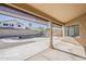 Covered patio with roll down sun shades overlooking a yard with a basketball hoop and fencing at 15360 N 87Th Ave, Peoria, AZ 85381